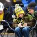 Michigan fans Logan Kirkey, 13, Joshua Johnson, 11, and Blake Wood, 10, all of Fenton, play on their phones as they tailgate before the start of the Northwestern game on Staurday. Melanie Maxwell I AnnArbor.com